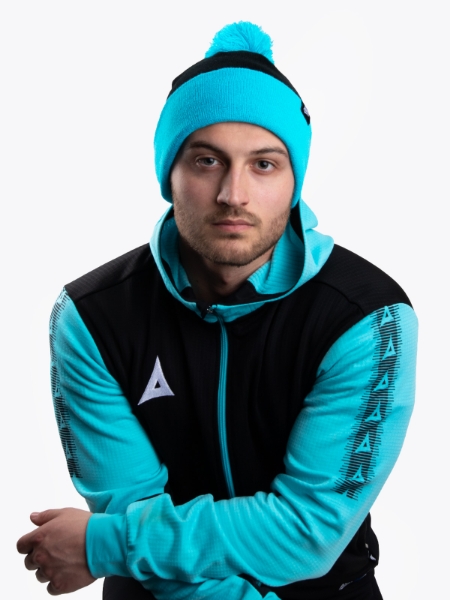 A man is wearing a Black and Blue Bobble Hat