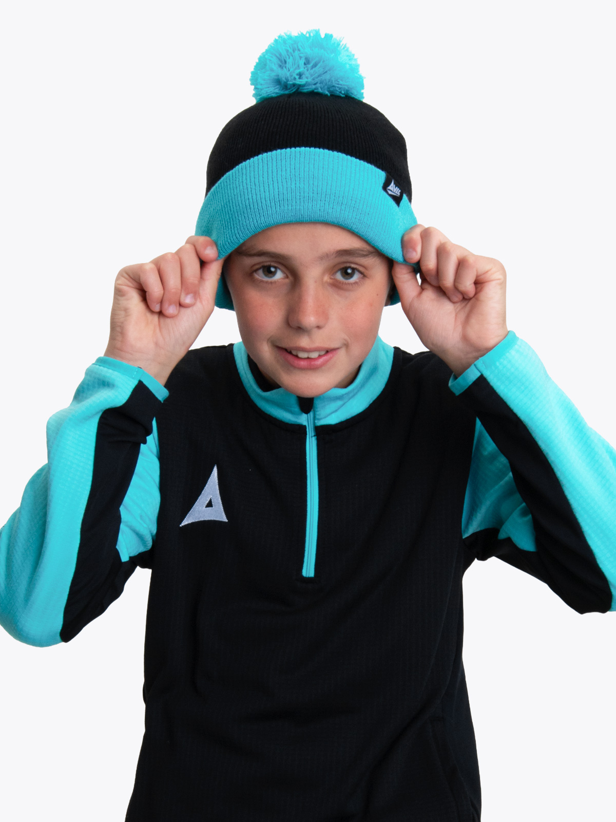 a young child wearing a black and blue bobble hat.