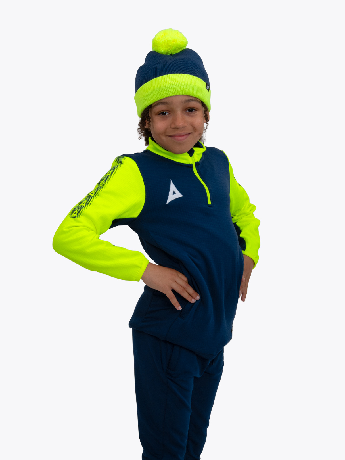 this child is wearing a junior bobble hat in navy and yellow, which can be worn as part of our pro player colleciton.