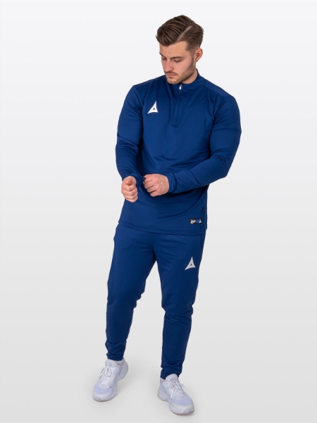 A Male Model is stood wearing the Avec Focus 2 Navy Tech Overlay, Plain Navy Jumper with a Quarter Zip and matching Avec Focus 2 Navy Track Pant