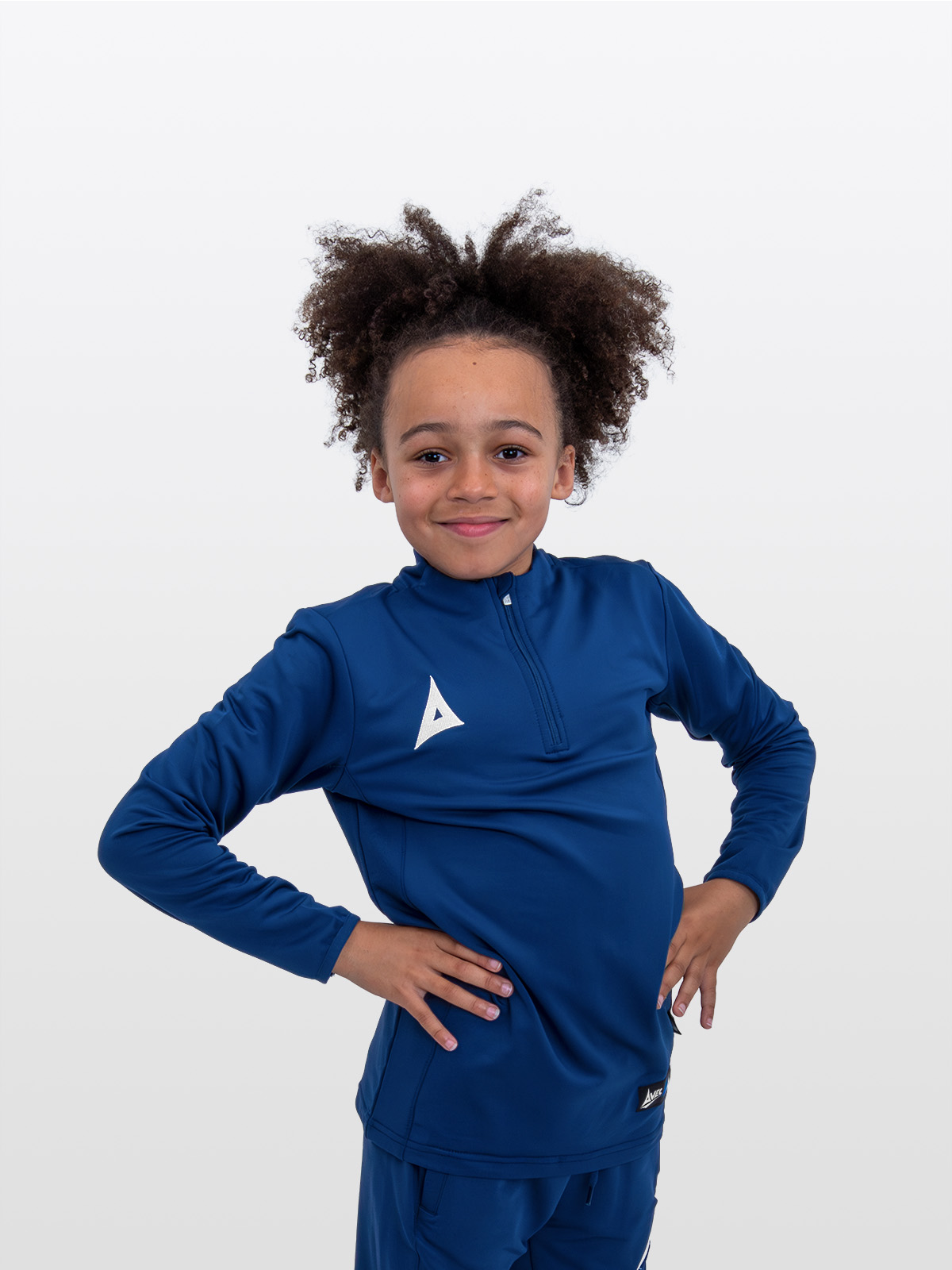 a boy is stood wearing the avec focus 2 navy tech overlay, plain navy jumper featuring a colour matched quarter zip