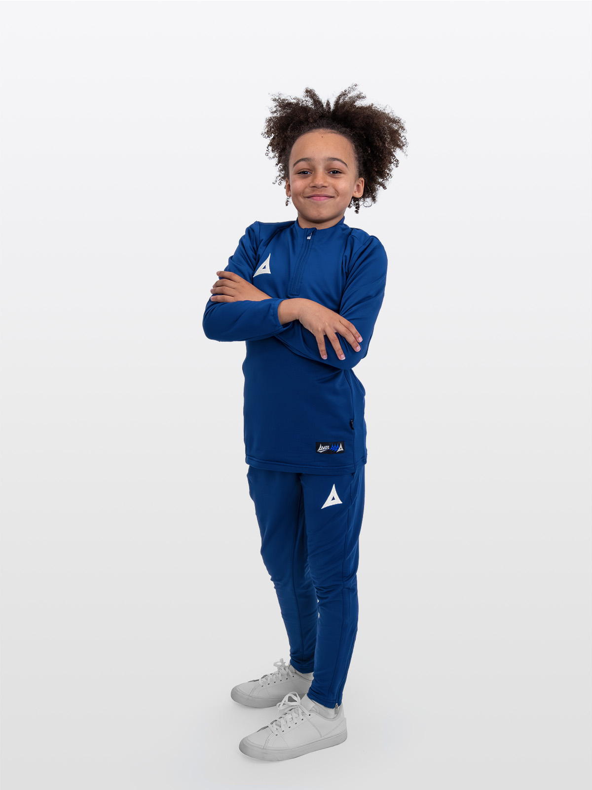 a boy is wearing the avec focus 2 red tech overlay paired with the avec focus 2 navy track pants.