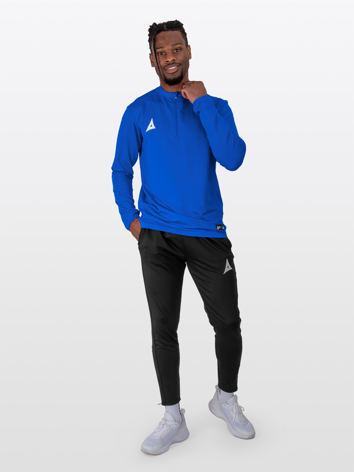 a male model dressed for training in the avec focus 2 royal tech overlay with a quarter-zip, paired with avec focus 2 black track pants.