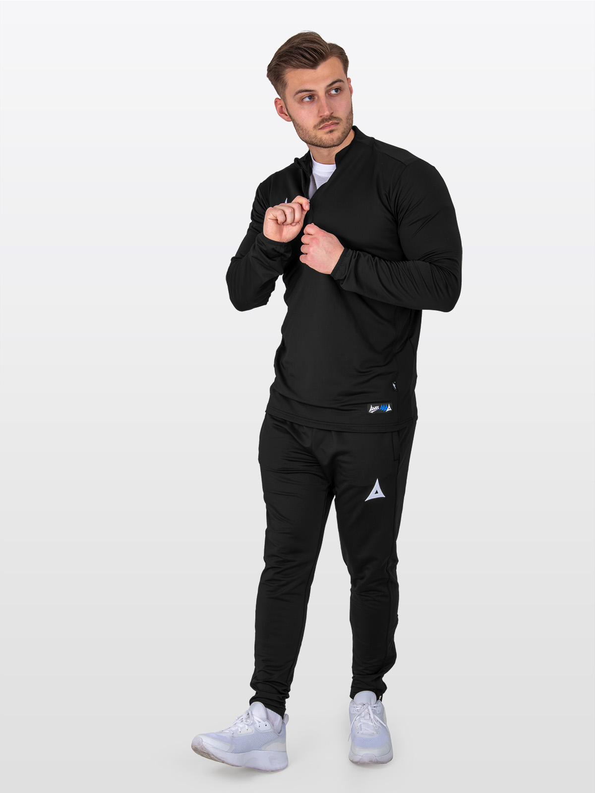 a male model wearing the avec focus 2 red tech overlay paired with matching black focus 2 track pants