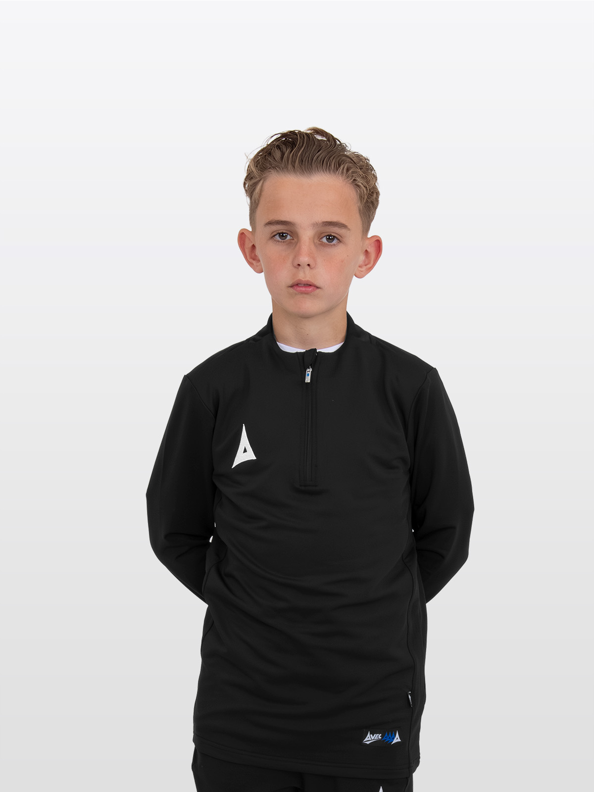 a boy is stood wearing the avec focus 2 black tech overlay, plain black jumper 