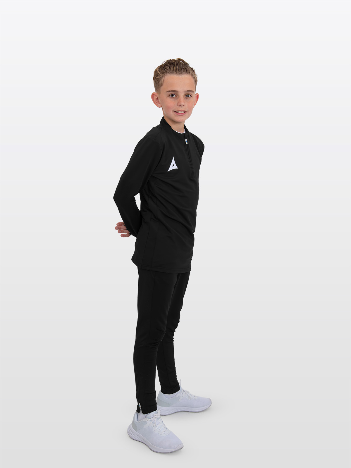 a boy wearing the avec focus 2 black tech overlay jumper, paired with avec focus 2 black track pants—perfect for kids’ training and sportswear.