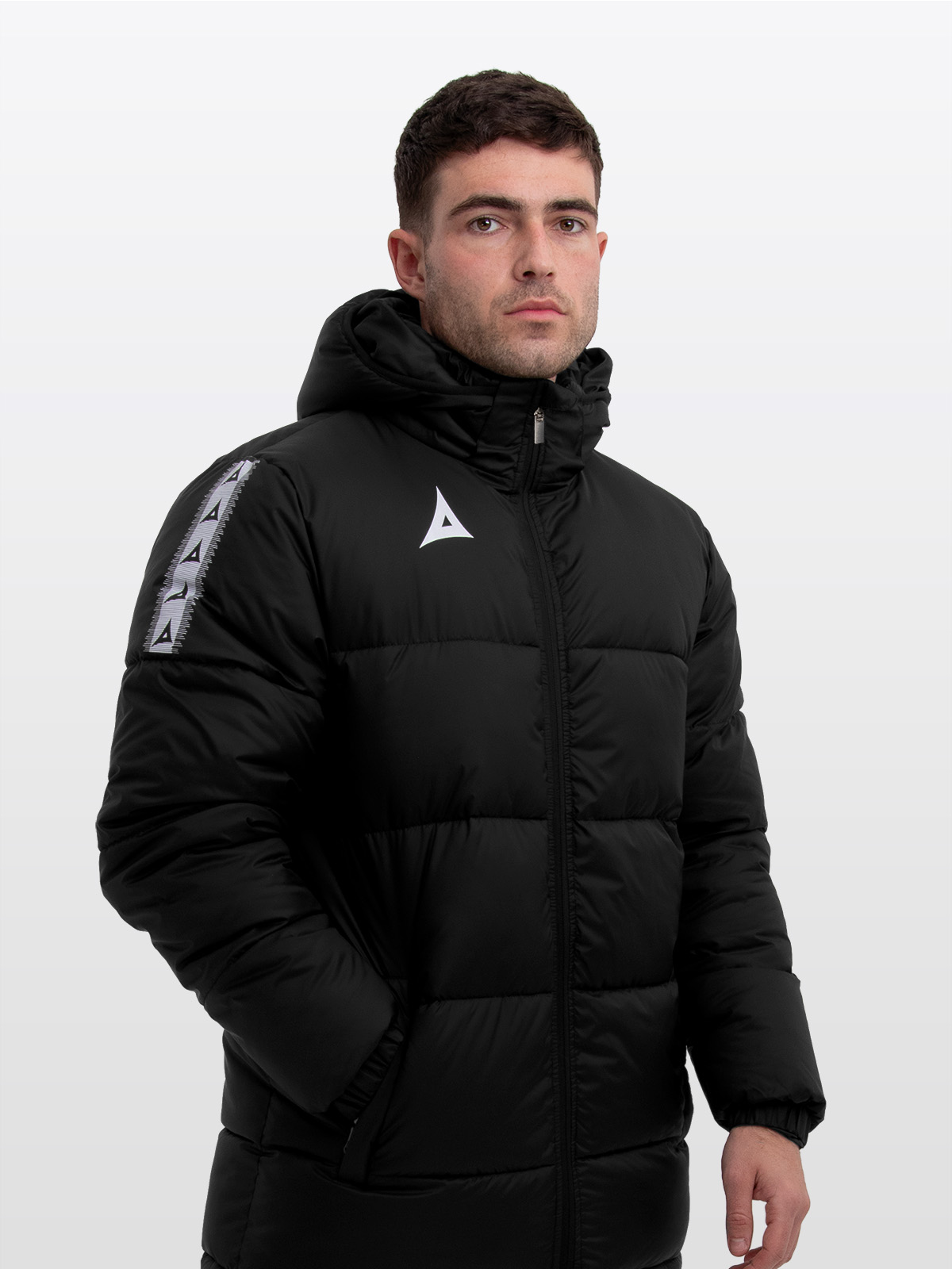 male model wearing the avec evolve pro padded jacket in black featuring medium padding for a refined, insulated fit and avec heritage ‘a’ contrast sleeve logo design