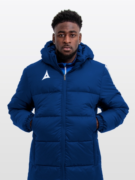 Male model wearing the Avec Evolve Pro Bench Coat in Navy, featuring insulated padding and panel detailing for premium warmth and pitch-side comfort.