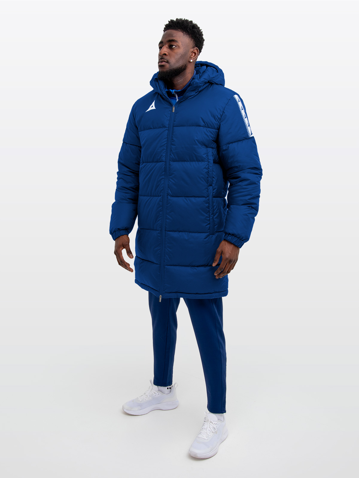 male model wearing the avec evolve pro padded jacket in navy with sewn-in panel detailing and medium fill, paired with matching navy evolve pro track pants for a styled, athletic look.