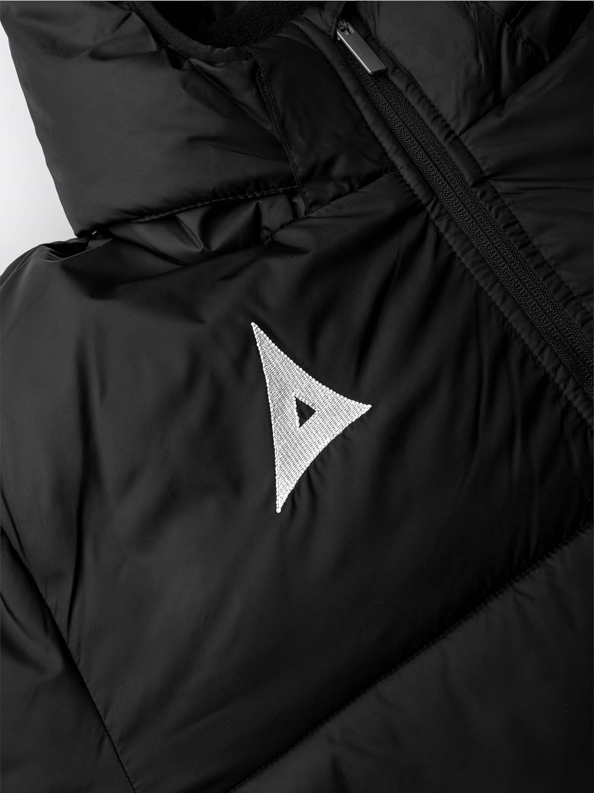 close up of the embroidery of the avec evolve pro padded bench jacket in black