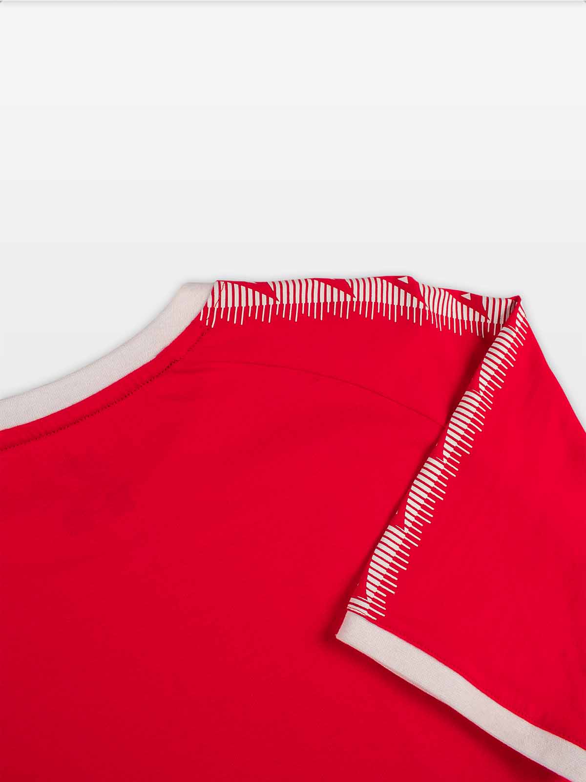 close-up of avec heritage 'a' logo taping on the avec evolve red t-shirt