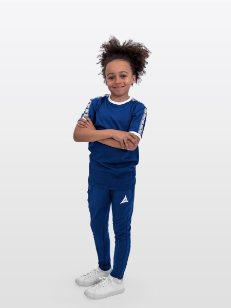 A Junior male Model wearing the Avec Evolve Navy T-Shirt with ribbed sleeve cuff and neck in white and matching Navy Avec Focus 2 Track Pants