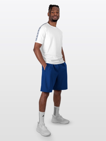 A Male Model is sat wearing the cotton Avec Evolve White T-Shirt, and Navy Avec Focus 2 Tech Shorts and Avec Grip socks in white