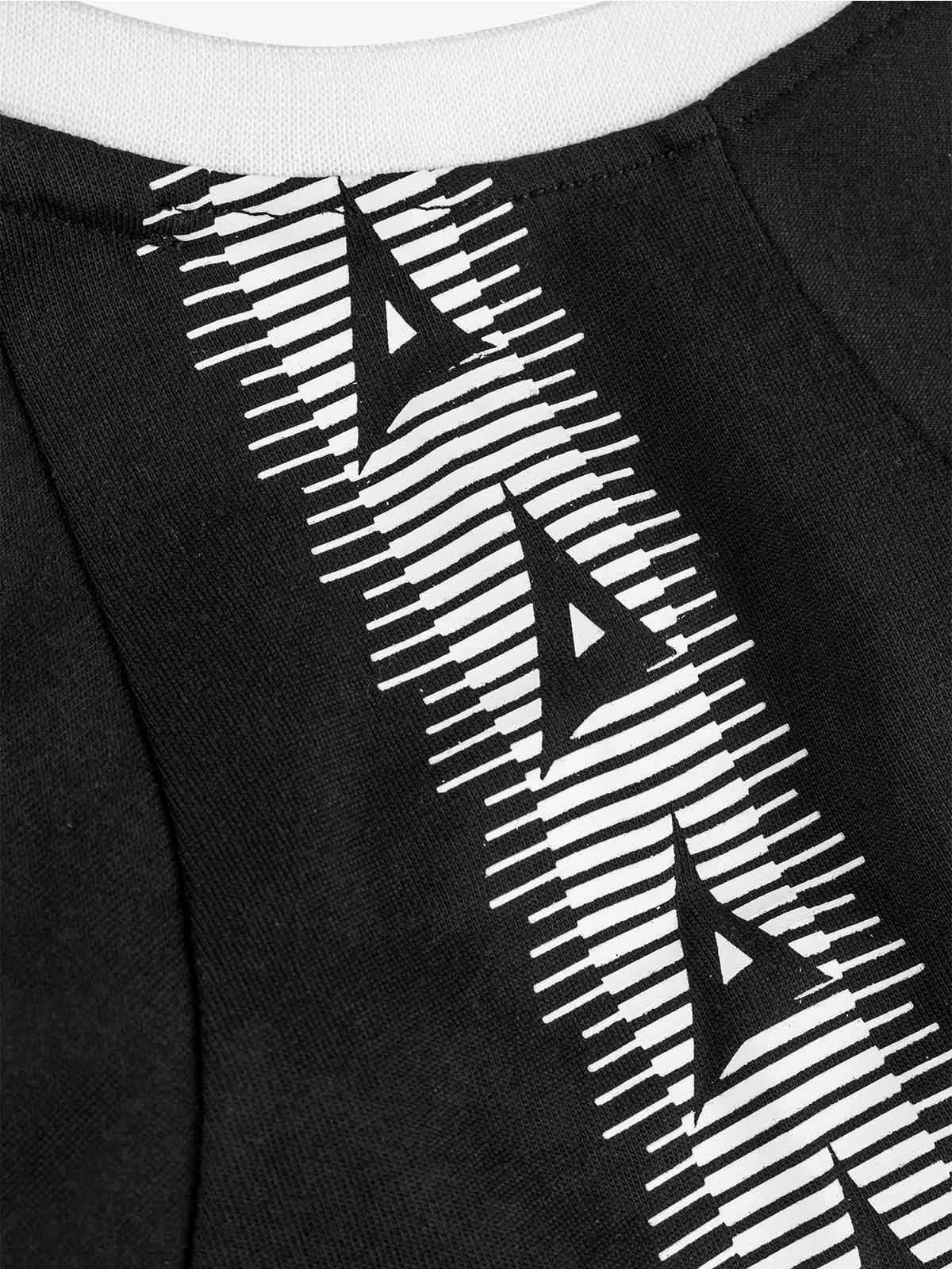 close-up of avec heritage 'a' logo taping on the avec evolve black t-shirt
