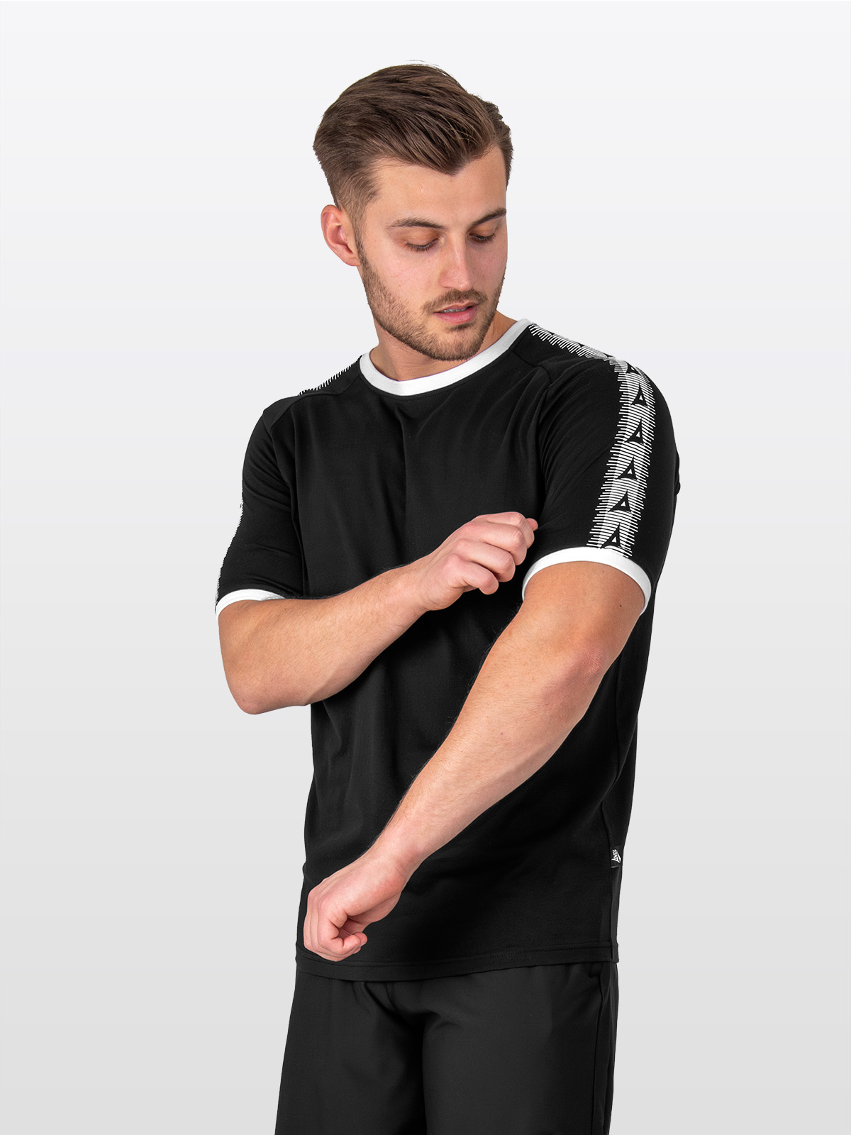 a male model wearing the avec evolve black cotton t-shirt, plain top with white sleeve cuff and collar