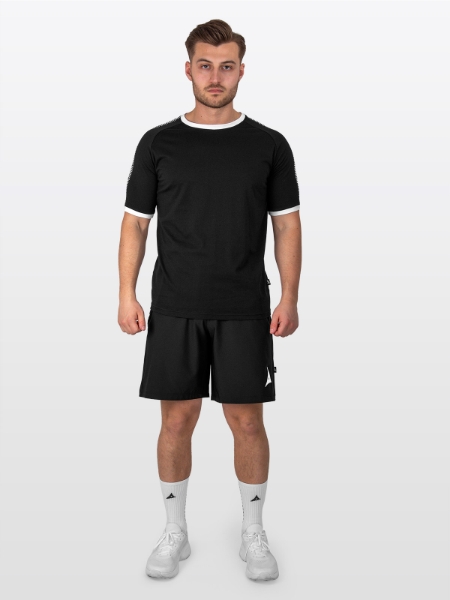 A Male Model is stood wearing the Avec Evolve Black T-Shirt, and Black Avec Focus 2 Tech Shorts and White Avec Grip Socks