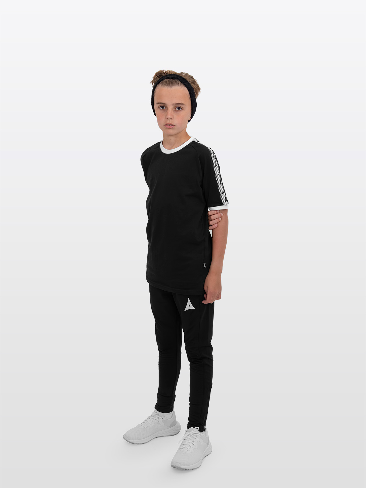 a boy is stood wearing wearing the avec evolve black t-shirt and the avec focus 2 black track pant