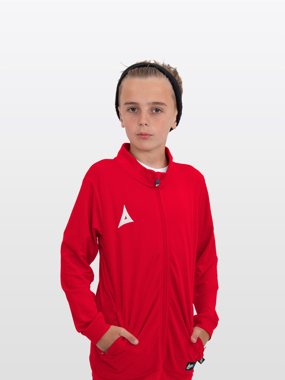 a boy is stood wearing the avec focus 2 red track jacket, plain red tracksuit a full zip