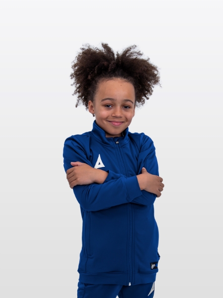 A boy is stood arms crossed wearing the Avec Focus 2 Navy Track Jacket