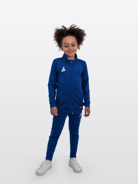 A boy is stood wearing a complete Avec Focus 2 Red Track Jacket and the Avec Focus 2 Navy Track Pant