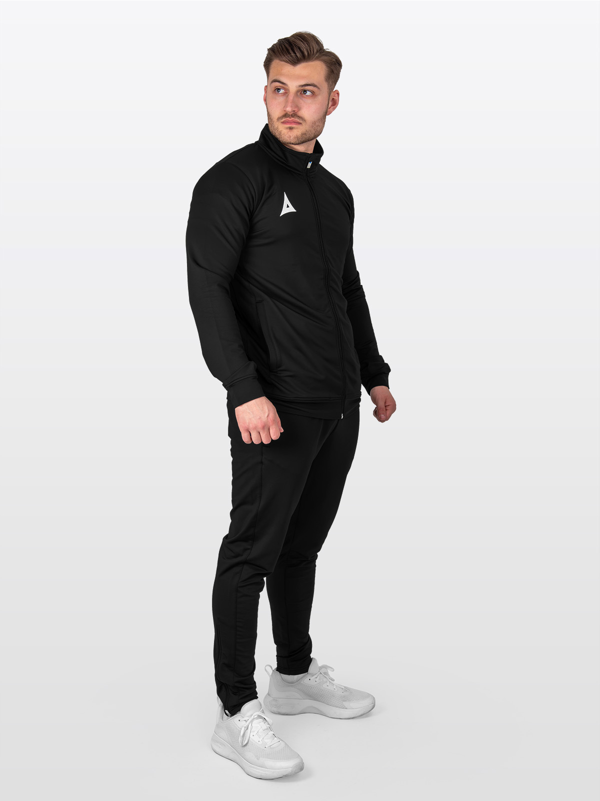 a male model wearing a full matching tracksuit. avec focus 2 black track jacket, and black focus 2 tech pant