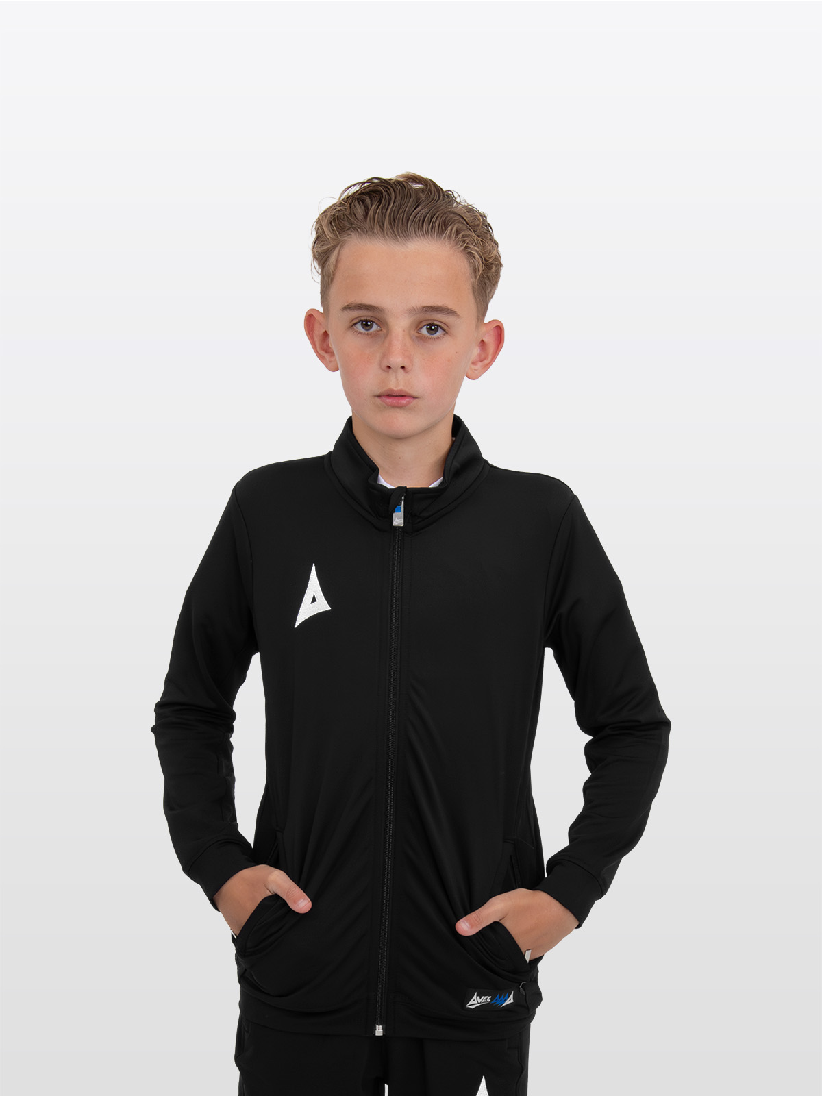 a boy is stood wearing the avec focus 2 black track jacket, plain tracksuit full zip