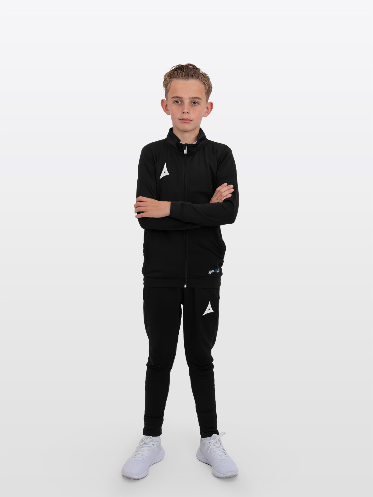 a boy is stood arms crossed wearing the avec focus 2 black track jacket, plain black full zip and the avec focus 2 black tech pant