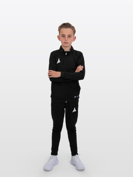A boy is stood arms crossed wearing the Avec Focus 2 Black Track Jacket, Plain Black full Zip and the Avec Focus 2 Black Tech Pant