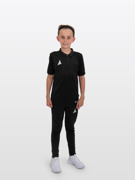 A boy is stood wearing the Avec Focus 2 Black Tech Polo and the Avec Focus 2 Black Tech Pant ready for training