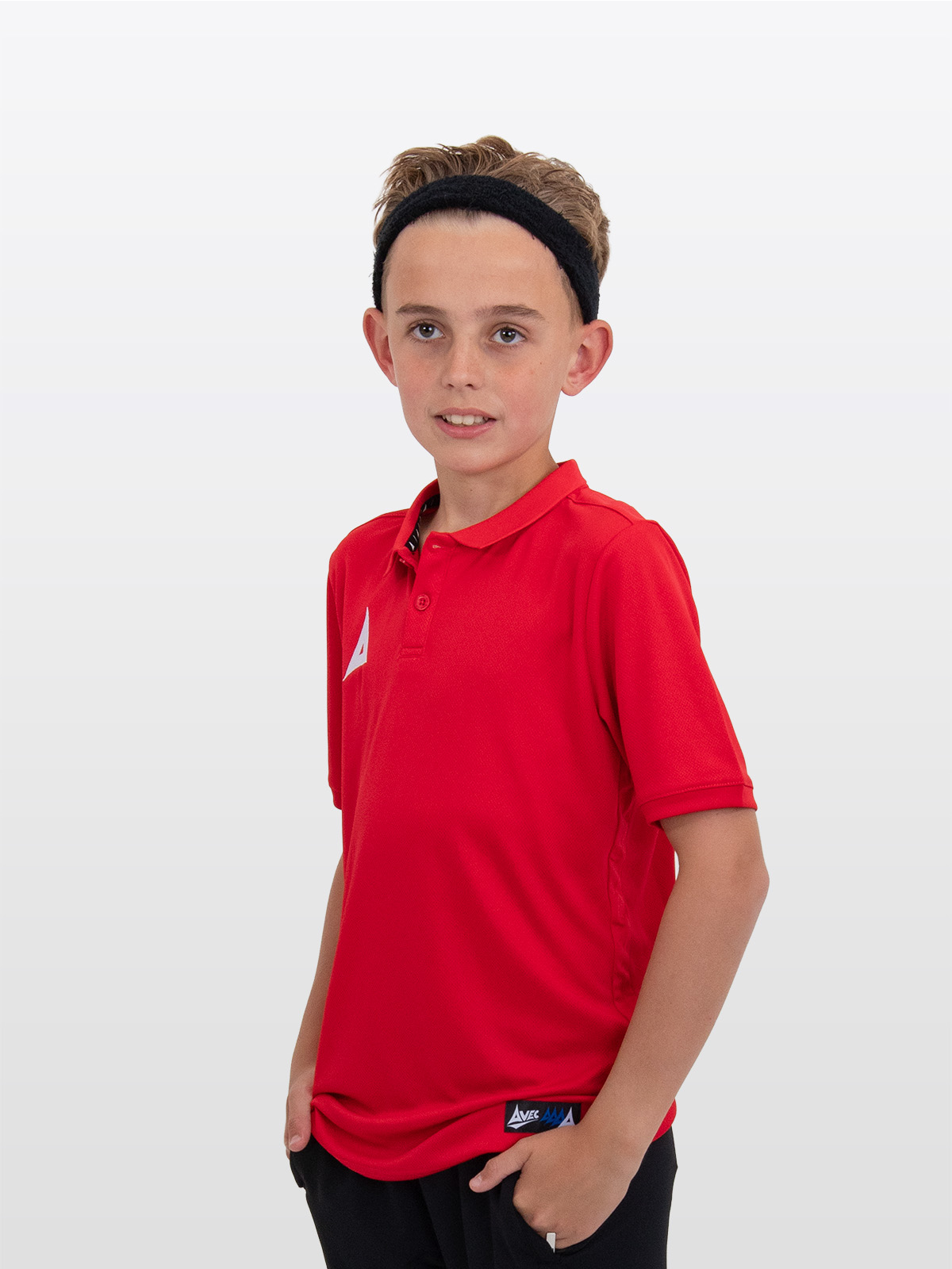 a blonde boy is wearing the avec focus 2 red tech polo and a black hairband