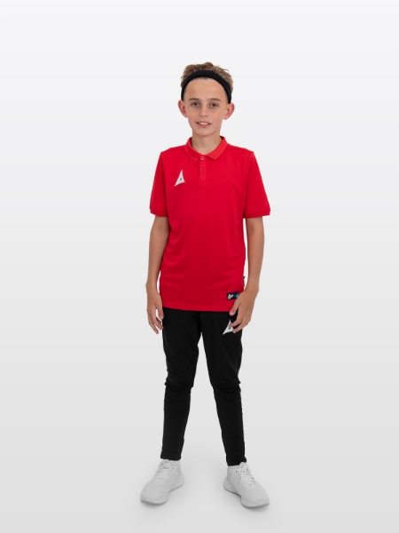 A boy is stood wearing the Avec Focus 2 Red Tech Polo and the Avec Focus 2 Black Track Pant, smart polo and joggers for training