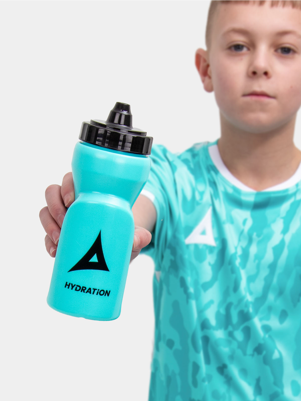 a kid is wearing a hyper blue football shirt and is holding a matching colour water bottle with a self sealing nozzle