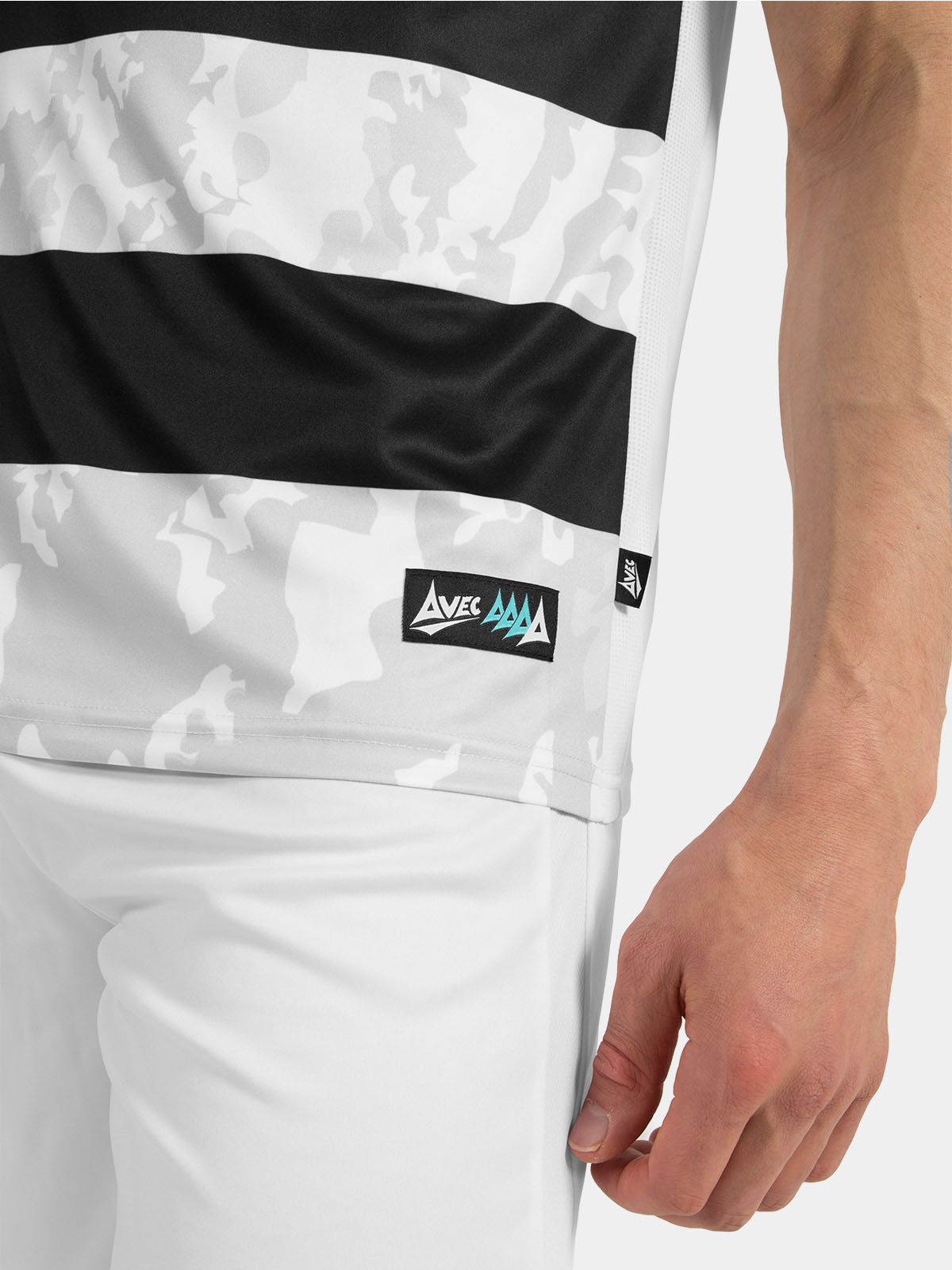 lower hem detail of the black and white jersey showing the authentic woven id label and side ventilation mesh.