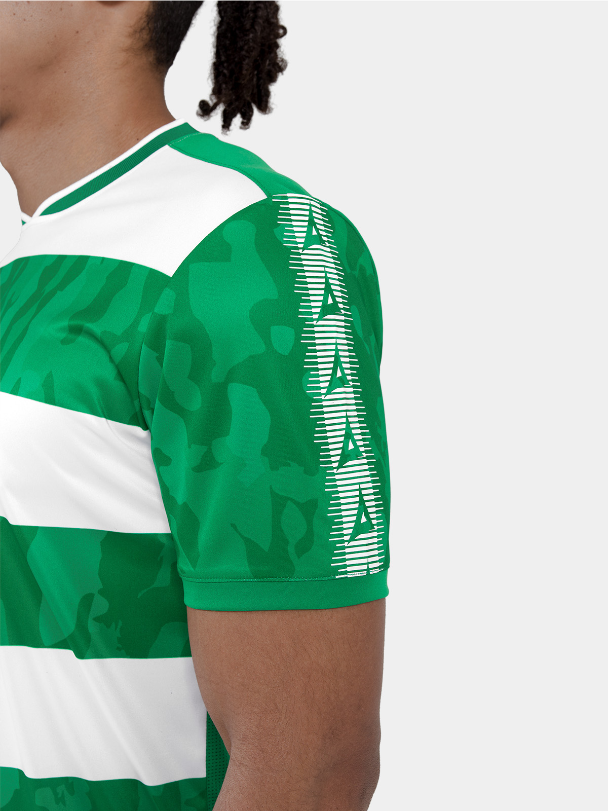 close-up of the green heritage 'a' sleeve panel and the sublimated camo texture within the hoops.