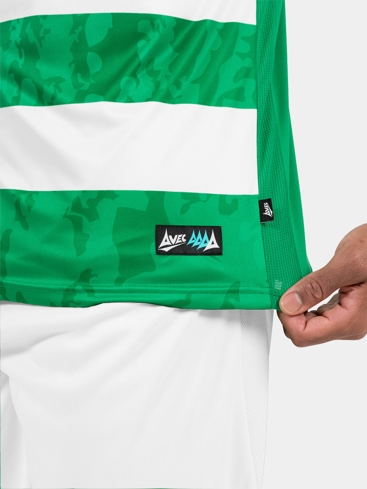 technical shot of the green and white jersey hem, featuring the official avec id label and breathable mesh.
