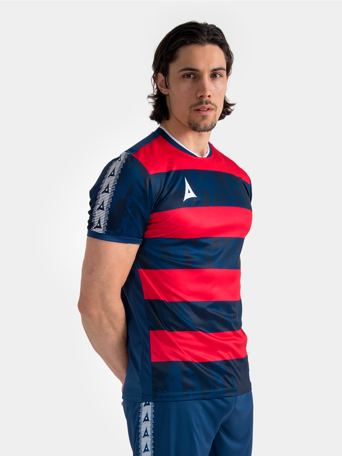 model showcasing the navy and red pro intent hoop jersey, highlighting the modern textured design and pro-fit.