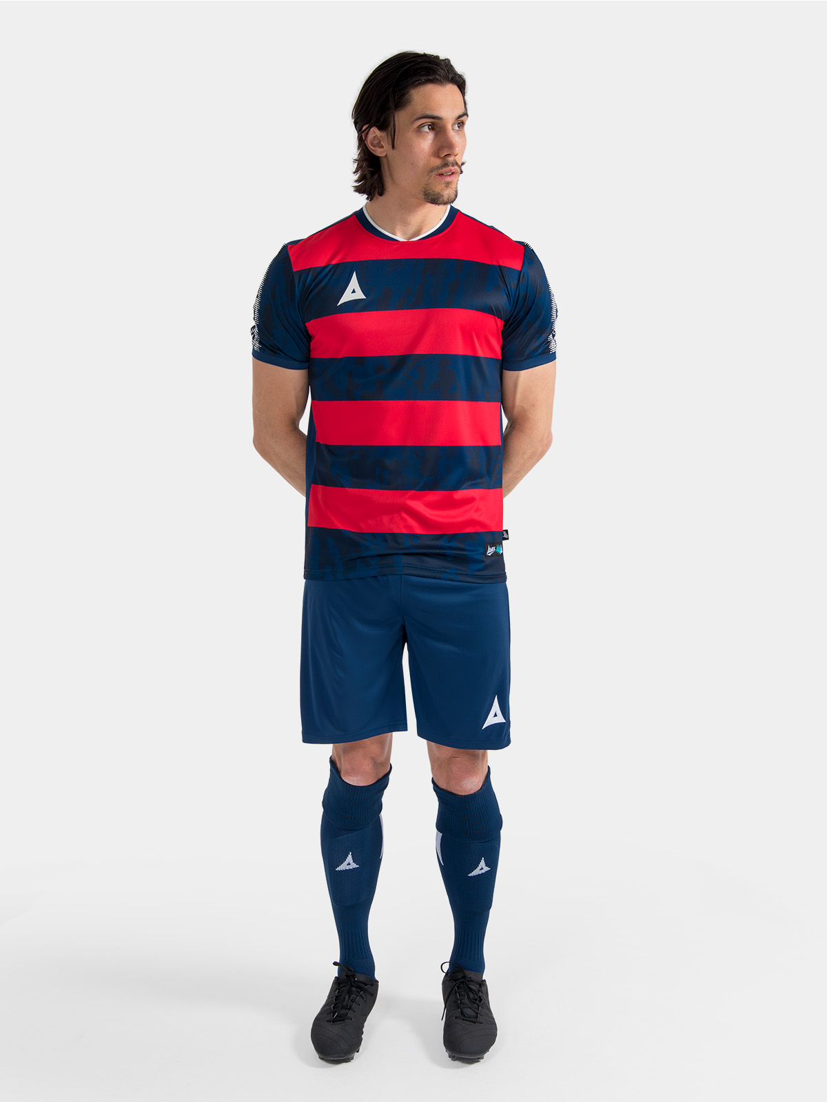 complete navy and red matchday kit on-model, demonstrating the professional on-pitch appearance.