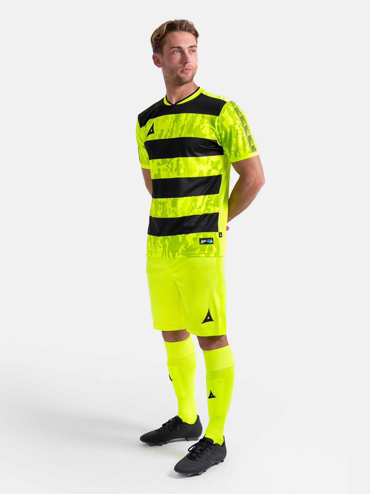 full body shot of the neon yellow and black pro intent kit, showing the high-visibility uniform on-model.