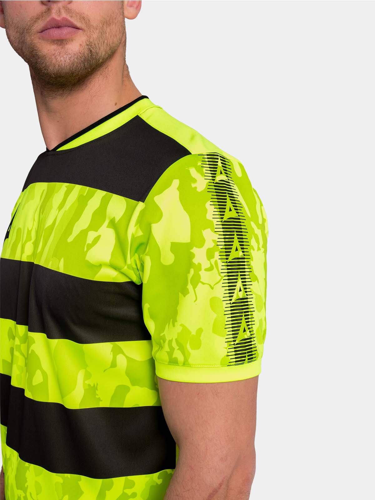 detailed shoulder shot of the neon yellow jersey featuring the black heritage sleeve branding.