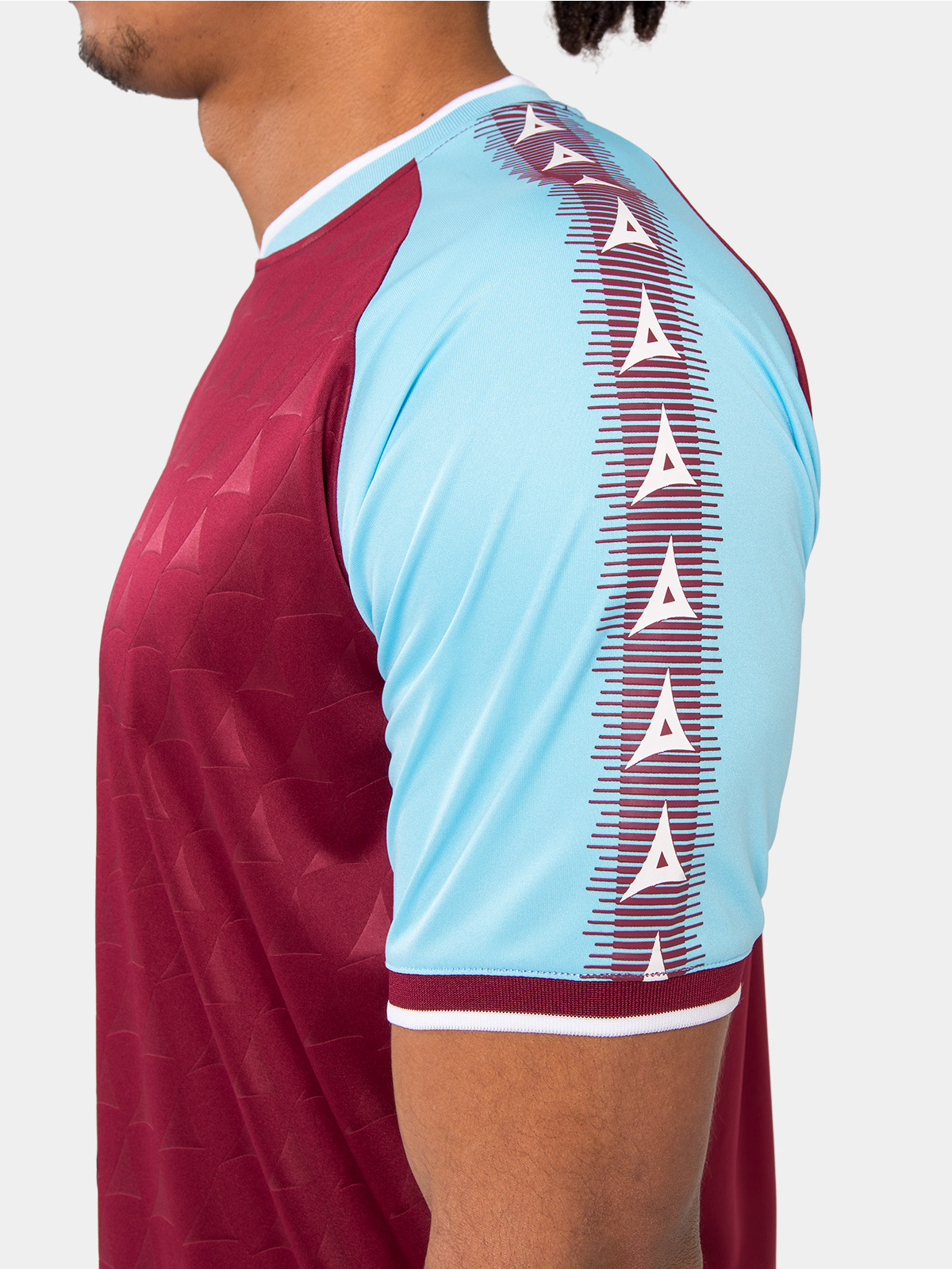 shoulder detail of the claret heritage jersey with sky blue branding.