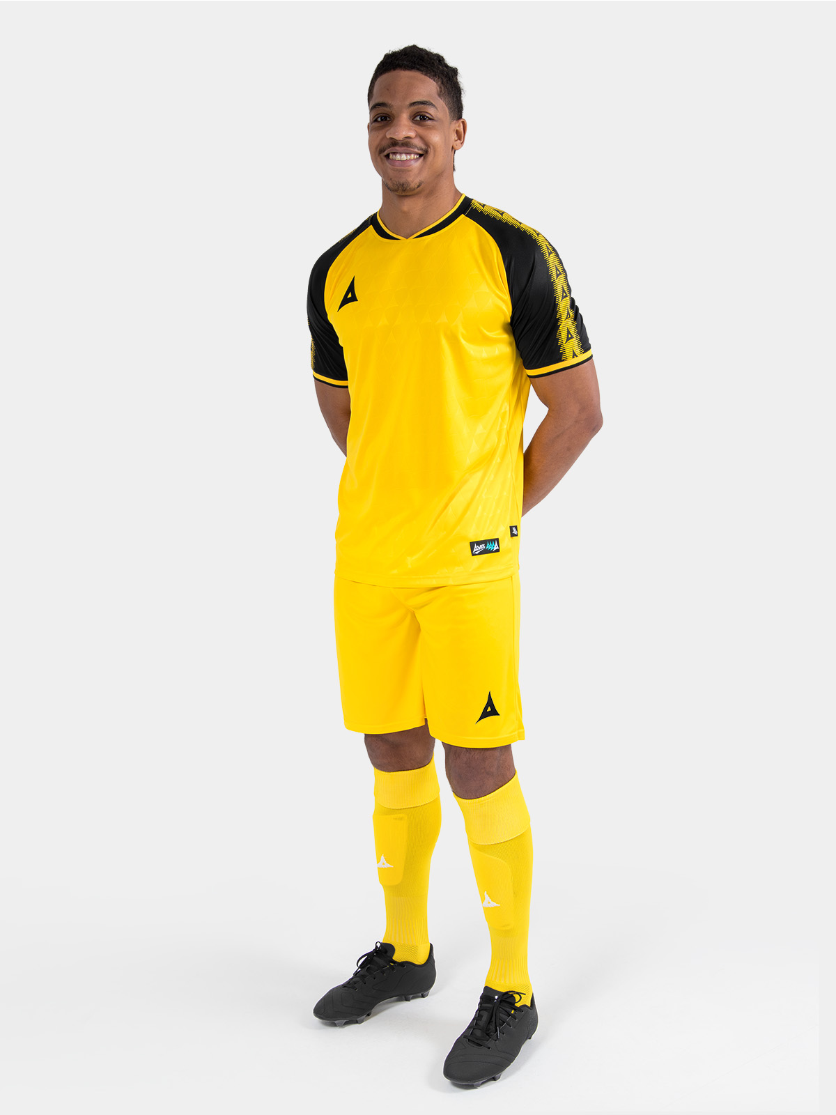 full body view of the yellow and black heritage matchday kit with matching shorts and socks.