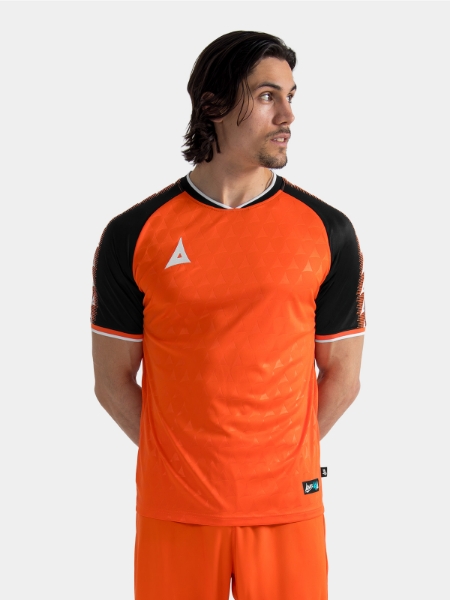 Upper body lifestyle shot of the Orange and Black Heritage Jersey on-model for matchday.