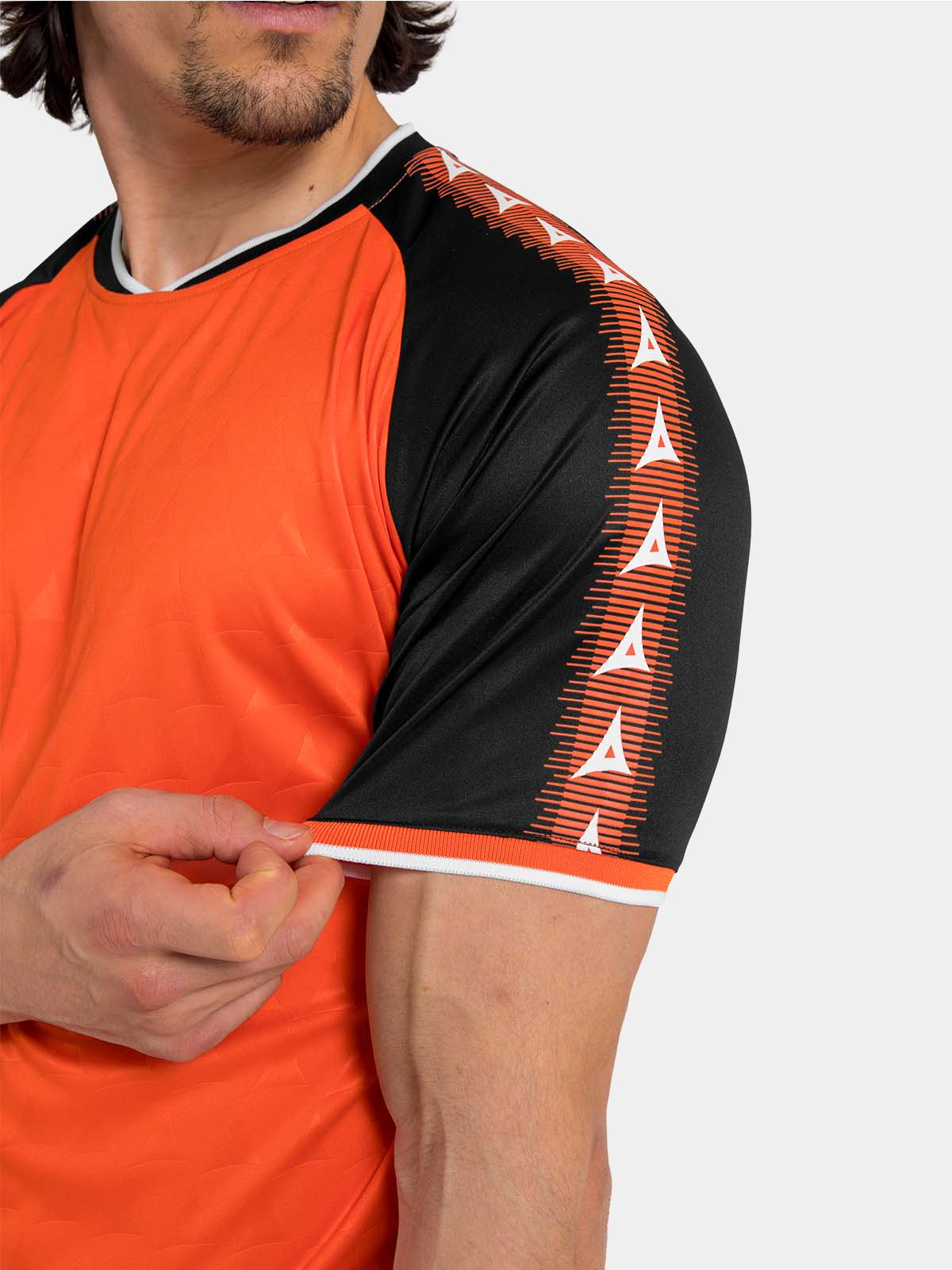 detailed view of the orange heritage jersey shoulder with signature contrast branding.