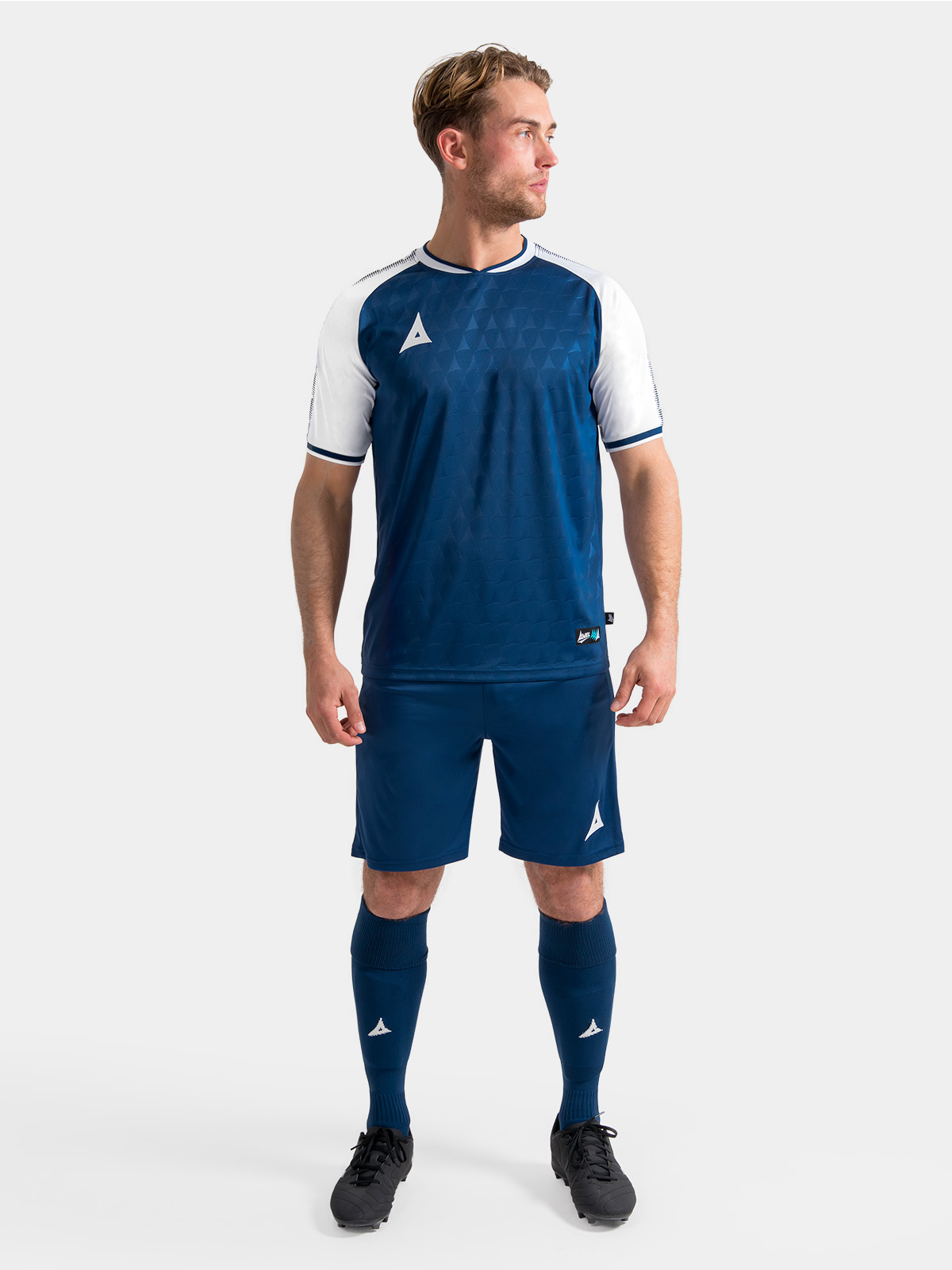 model wearing the complete navy and white heritage matchday kit for a professional squad look.