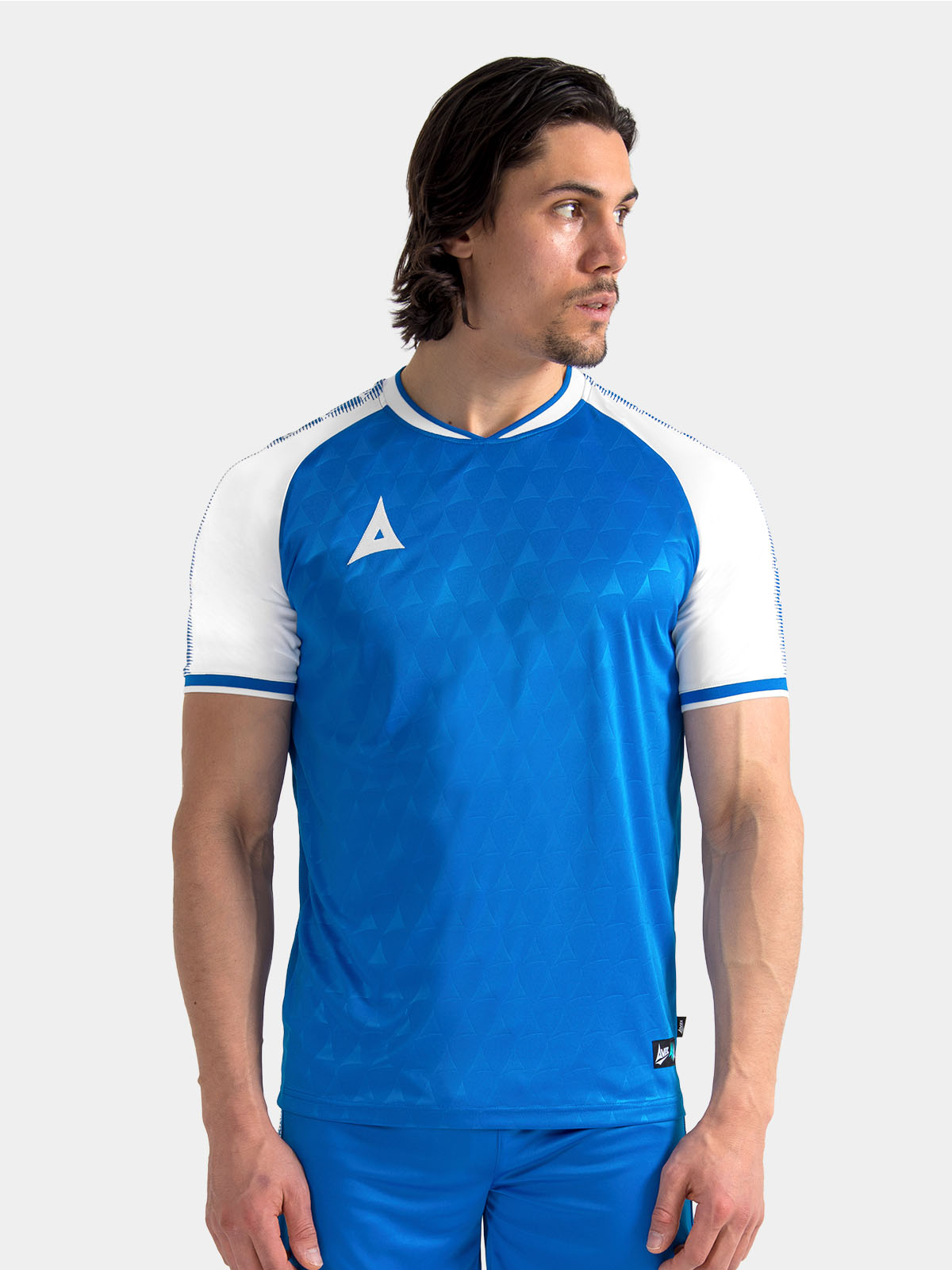 model wearing the royal blue and white heritage jersey, highlighting the soft-feel neckline.