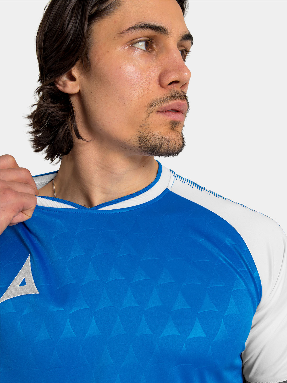 close-up of the v-neck collar on the royal blue and white heritage matchday jersey.