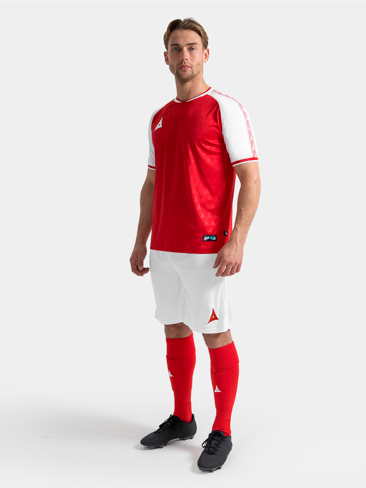 full body kit shot of the red and white heritage jersey with white shorts and red socks.