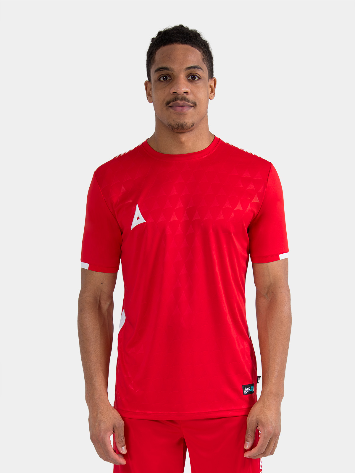 footballer wearing the red evolve pro training jersey, illustrating the professional athletic fit.