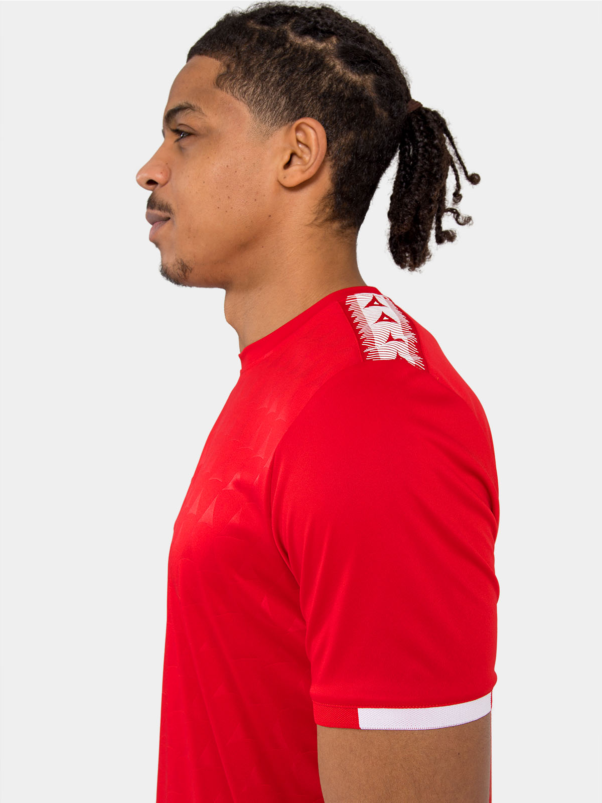 technical detail of the red jersey shoulder featuring the heritage 'a' logo tape.