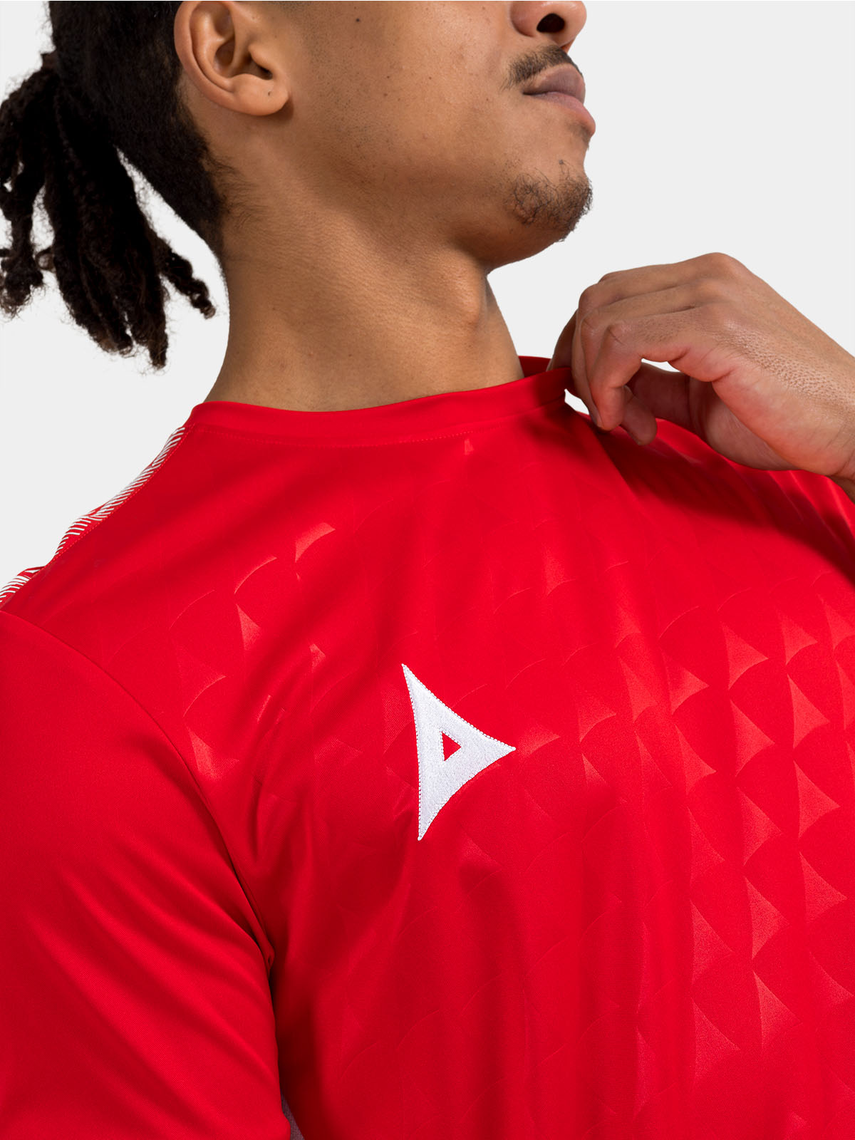 close up shot of the repeating debossed 'a' logo pattern on the red front panel.